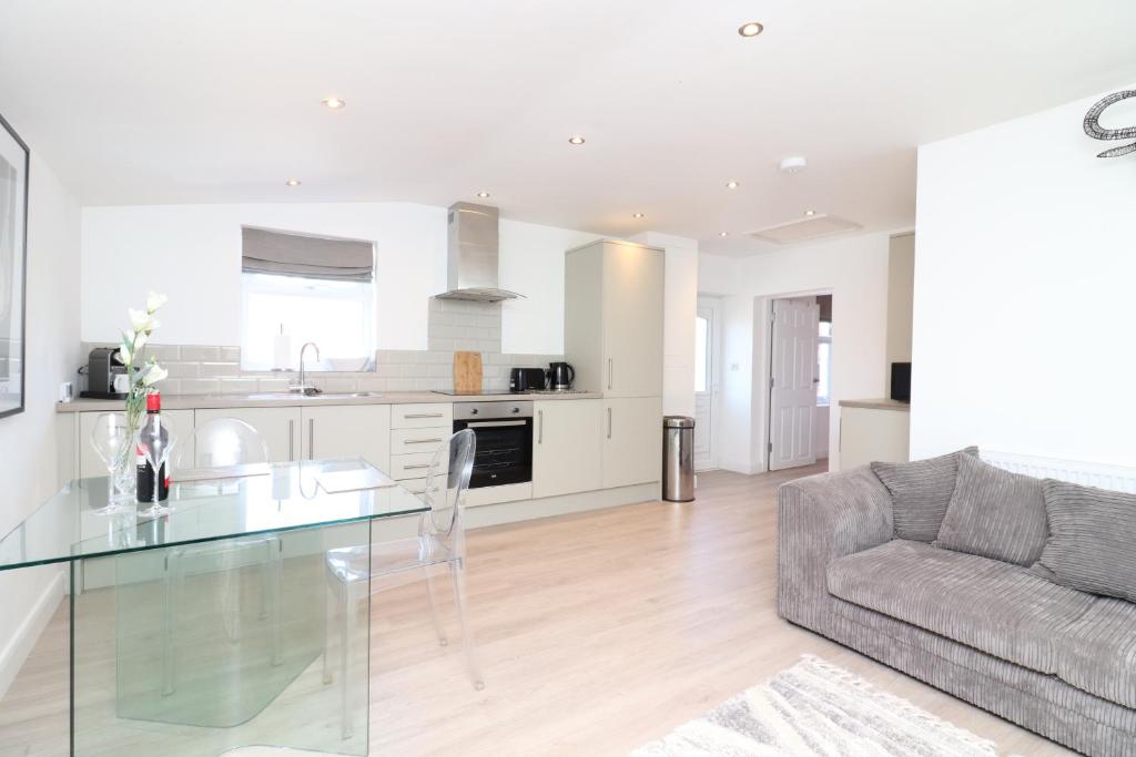 a living room with a glass table and a couch at Hope House Apartments in Chester