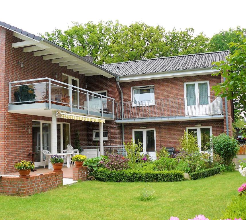a brick house with a balcony and a yard at Sasishaus in Hamburg
