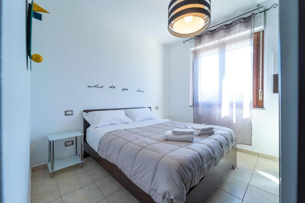 a bedroom with a large bed and a window at Sweet Sea in Alghero