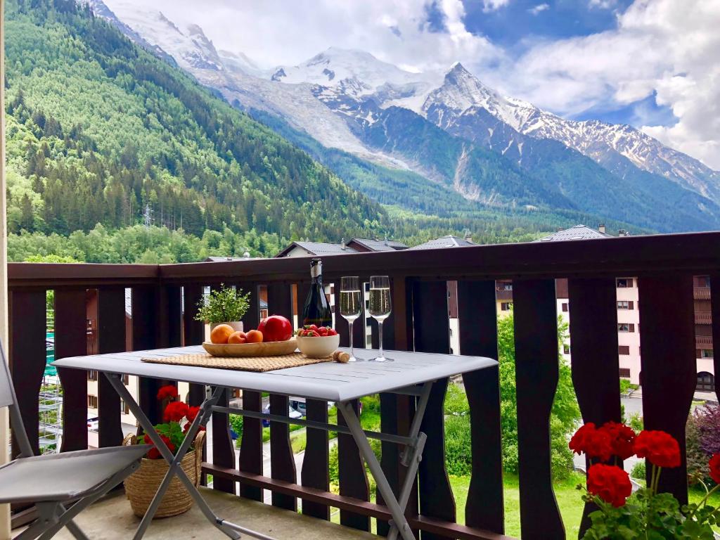 a table on a balcony with a view of mountains at Mont Blanc 43, vue Mont Blanc , balcon, parking in Chamonix
