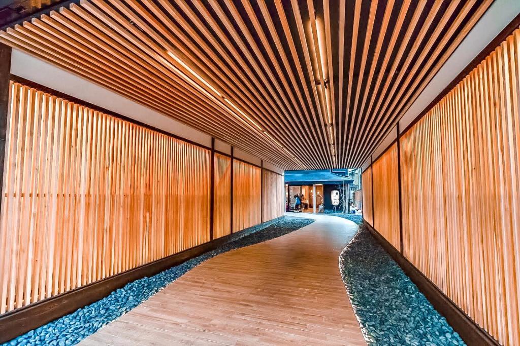 a hallway with wooden walls and a wooden floor at Hotel Imagine Kyoto in Kyoto