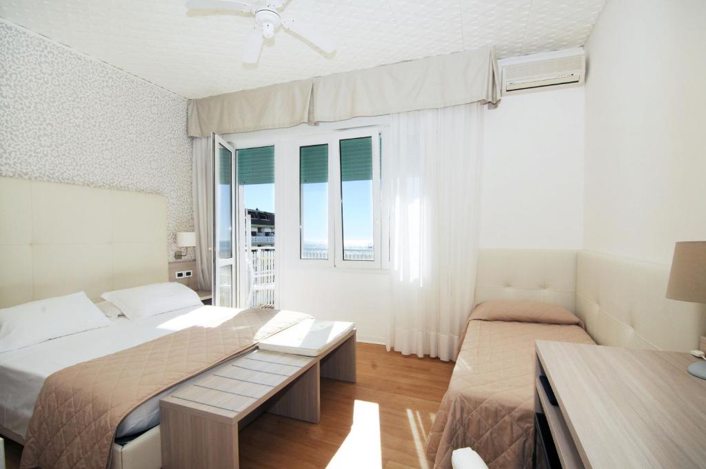 Postel nebo postele na pokoji v ubytování Hotel Splendid