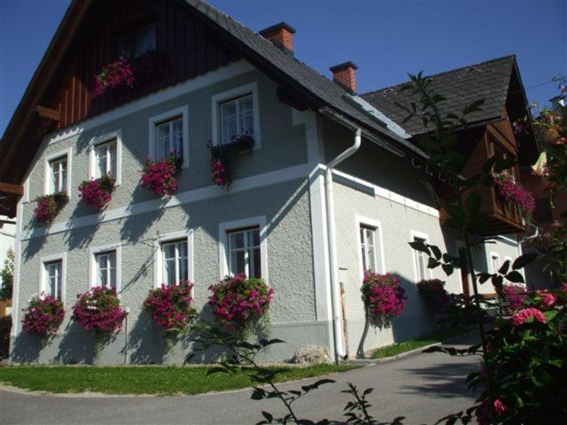 a white house with flowers on the side of it at Gross Lettenwag in Göstling an der Ybbs