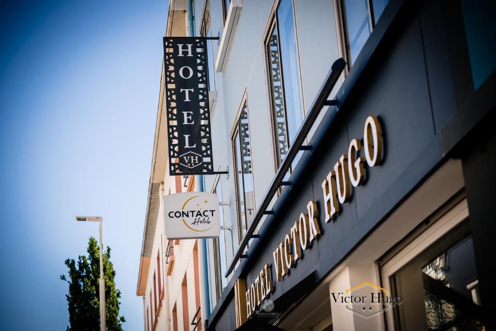 a sign for a restaurant on the side of a building at Hôtel Victor Hugo Lorient in Lorient