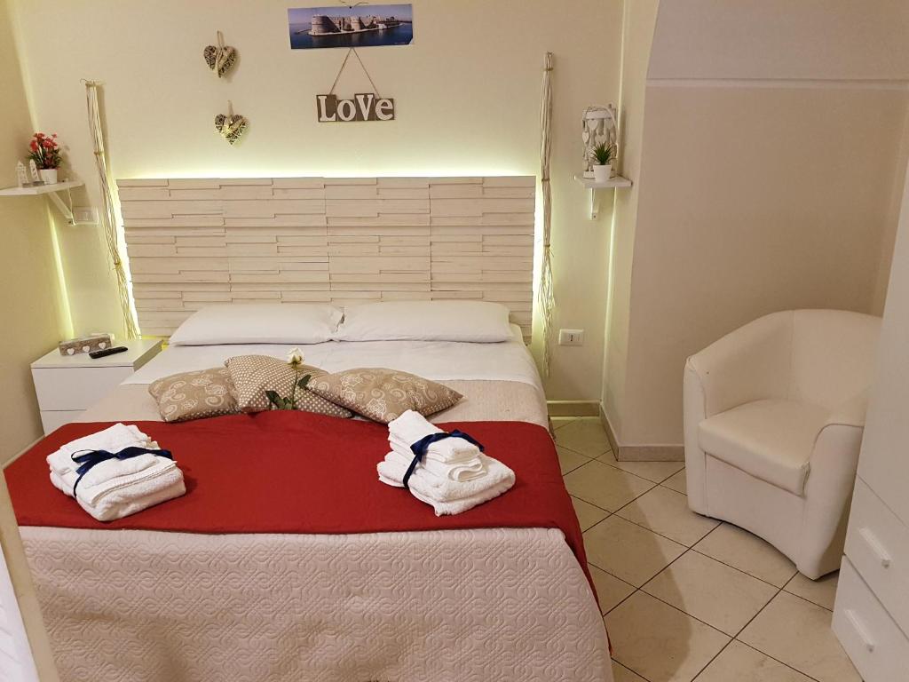 a bedroom with two beds with towels on it at Philos - Appartements & Rooms in Taranto