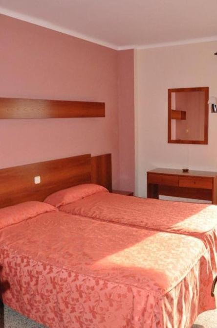 Posteľ alebo postele v izbe v ubytovaní Hotel Haromar