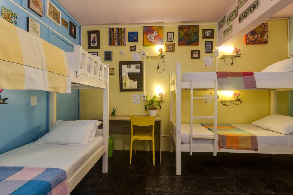 a room with two bunk beds and a desk at Fit Hostel in Recife