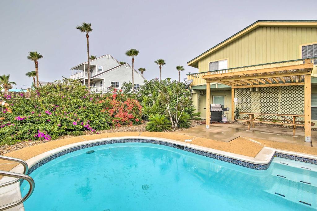 a swimming pool in front of a house at South Padre Island Oasis with Pool Walk to Beach! in South Padre Island