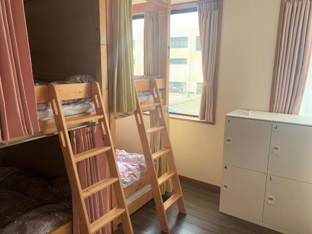 a room with two bunk beds and a window at Sado - Hotel - Vacation STAY 82483 in Sado