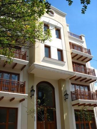 a white building with windows and balconies on it at Santa Fe Suites Apart in Salta