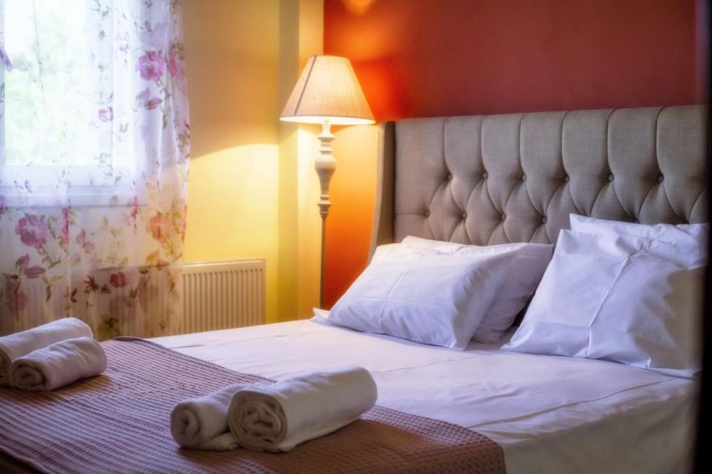 a bedroom with a bed with towels on it at Jasmine in Preveza