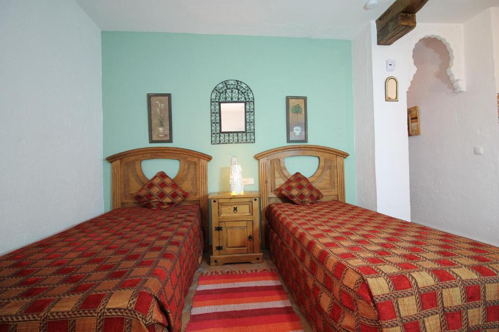 Posteľ alebo postele v izbe v ubytovaní Casas Rurales Juzcar Centro