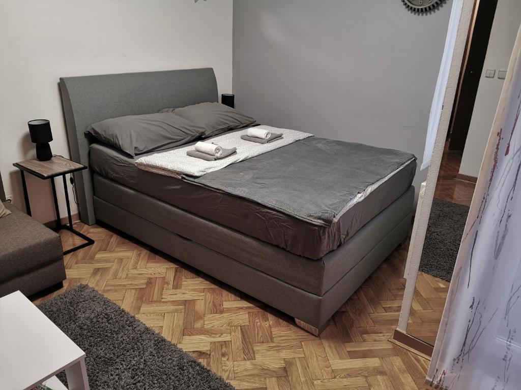 a large bed in a room with at TIME KEEPER - SELF check in in Osijek