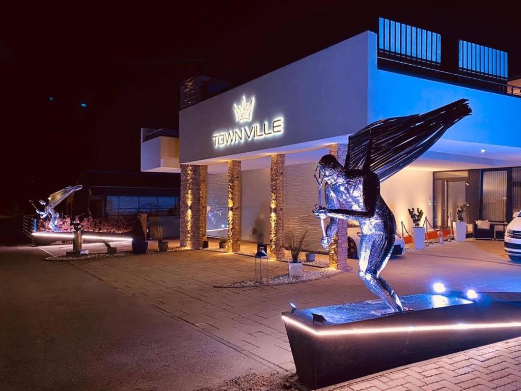 a metal statue of a woman in front of a building at TownVille in Flachau