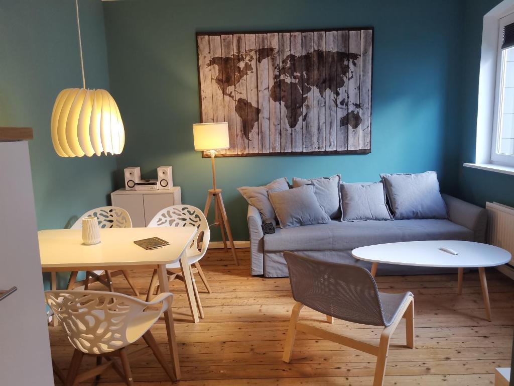 a living room with a couch and a table at Westliche Höhe in Flensburg