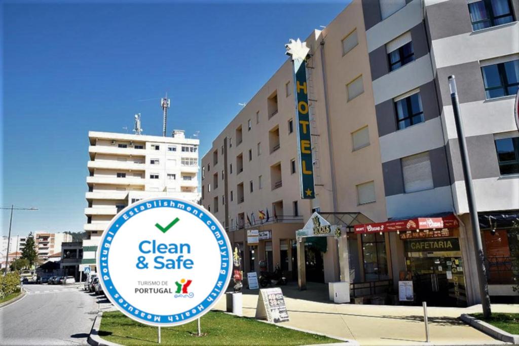 a sign for clean and safe in front of a building at Hotel Val Flores in Valença