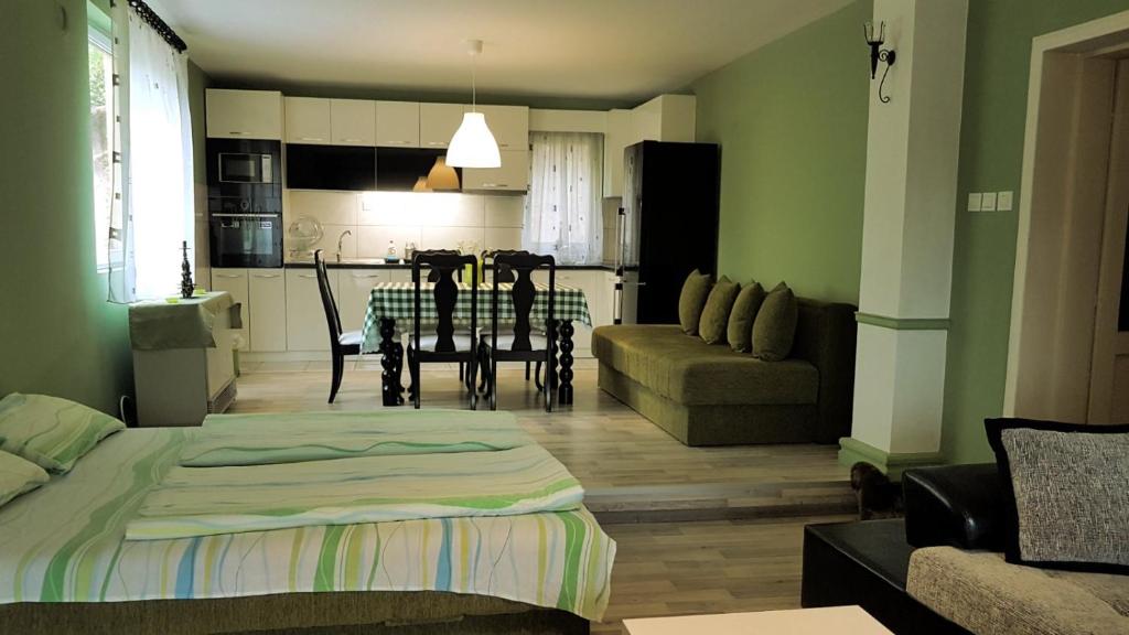 a living room with a bed and a dining room at BANJSKI PUT in Niš