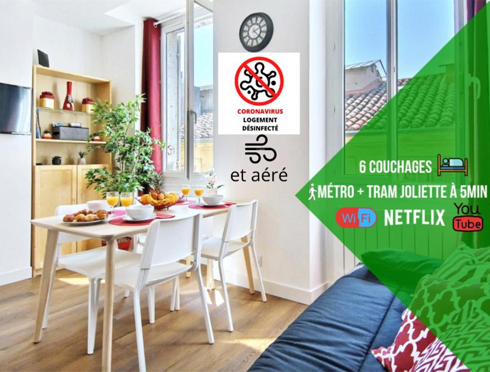 a dining room with a table and white chairs at 6 Couchages, Wifi Fibre & NETFLIX "experience-immo" in Marseille