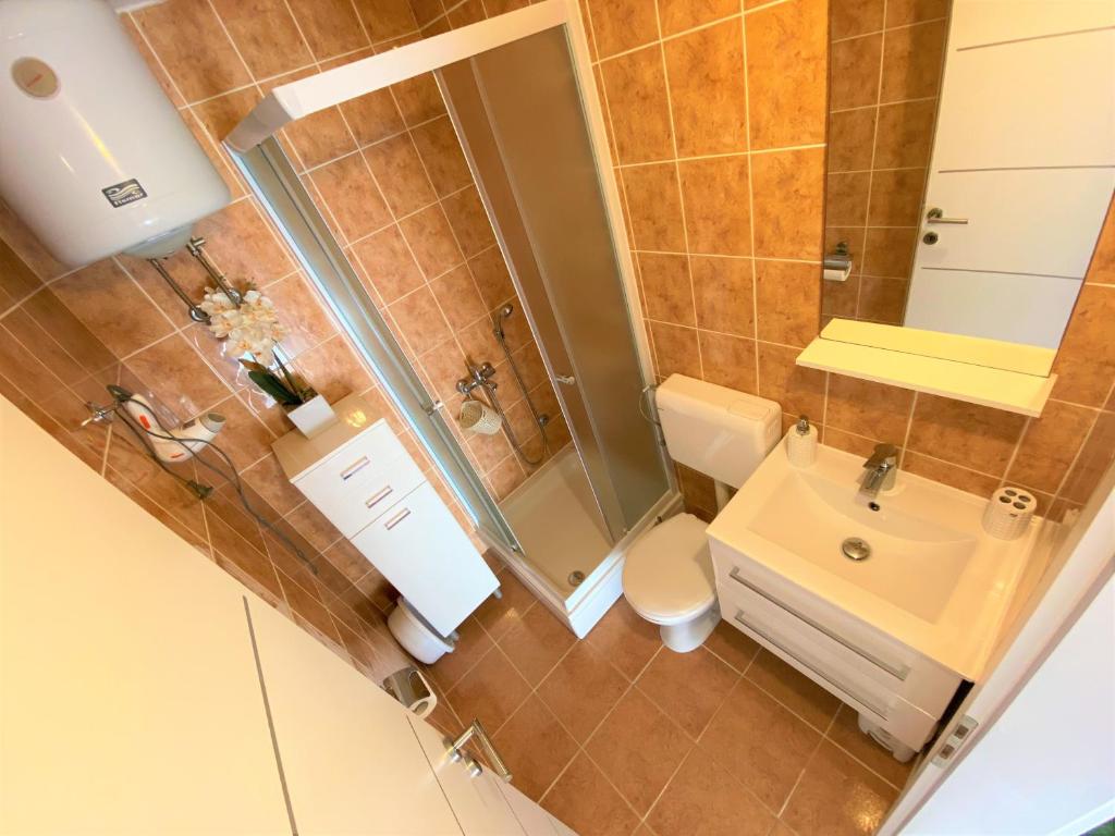 a bathroom with a shower and a toilet and a sink at Apartment Beach in Makarska