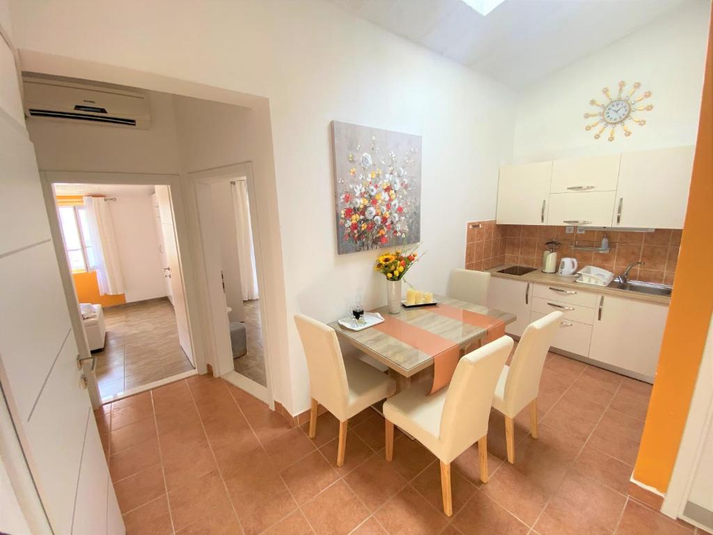 a kitchen and dining room with a table and chairs at Apartment Beach in Makarska