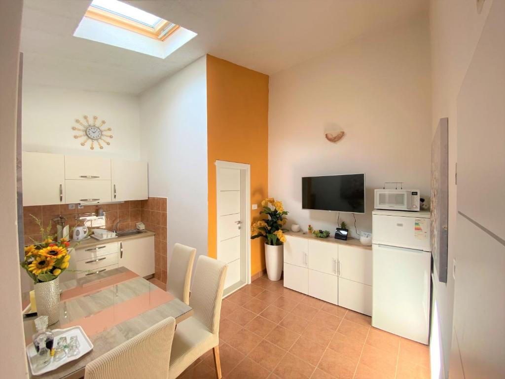a kitchen with a table with chairs and a refrigerator at Apartment Beach in Makarska