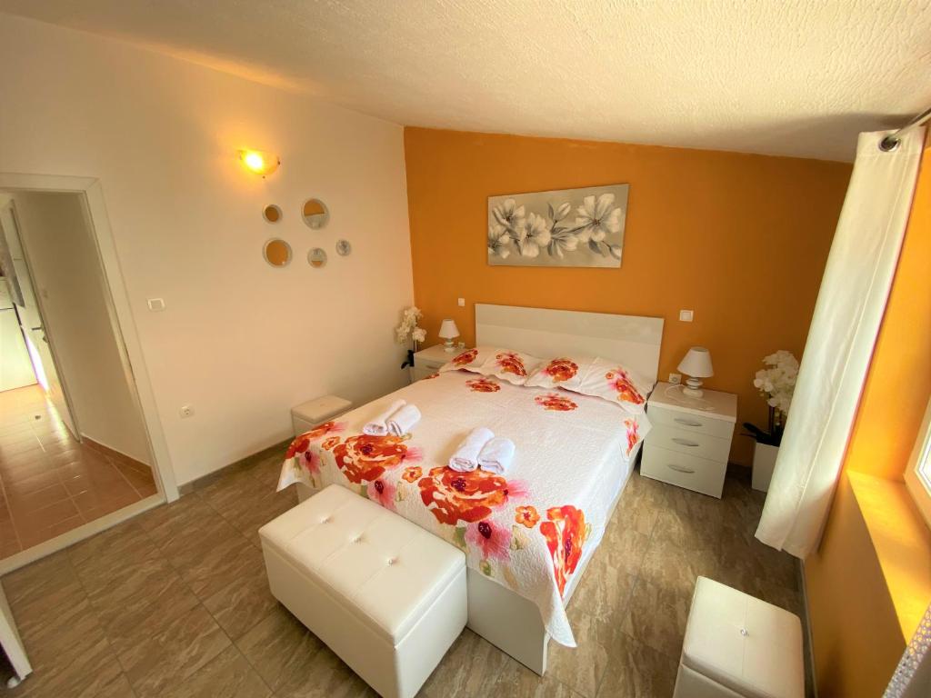 a bedroom with a large bed with orange walls at Apartment Beach in Makarska