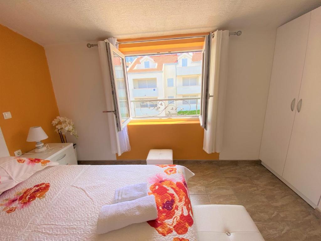 a small bedroom with a bed and a window at Apartment Beach in Makarska