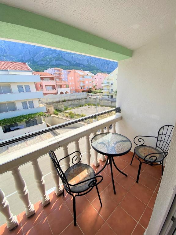 a balcony with two chairs and a table with a view at Apartment Beach in Makarska