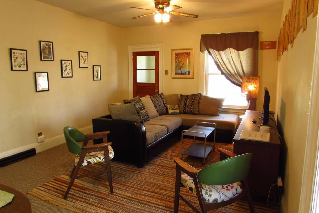 a living room with a couch and a table at Falls Retreat - Walk to the Falls, the Casino and all Downtown Restaurants - Across from the Aquarium in Niagara Falls