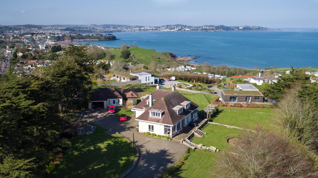 an aerial view of a house with a view of the water at Chauffeurs Cottage at The Stoep in Paignton