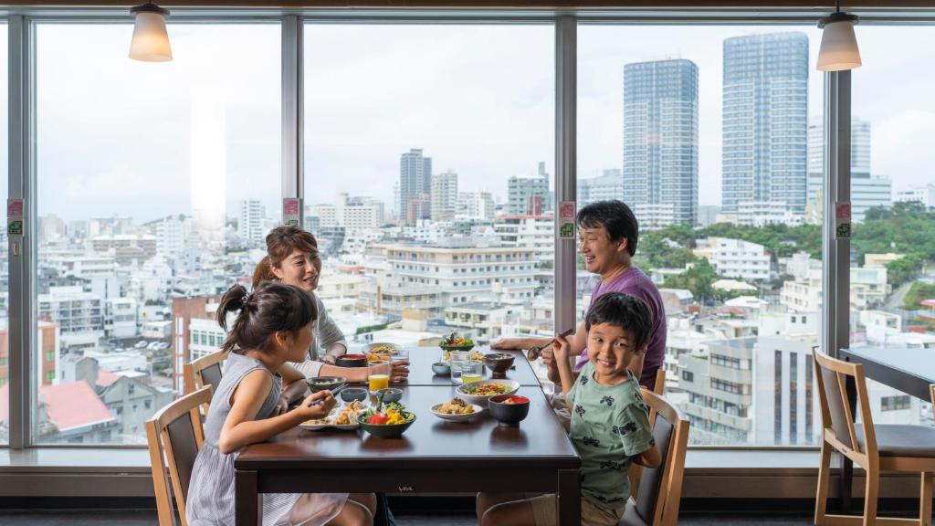 a group of people sitting at a table eating food at Hotel Ocean (Kokusai-Dori) in Naha