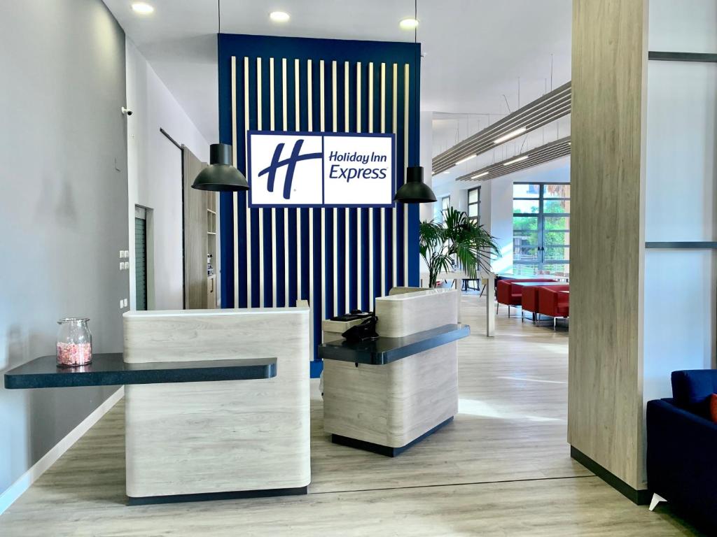 a lobby with a reception desk in a building at Holiday Inn Express Ciudad de las Ciencias, an IHG Hotel in Valencia