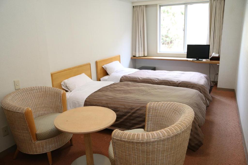 Nishiizu Crystal View Hotel客房内的一张或多张床位