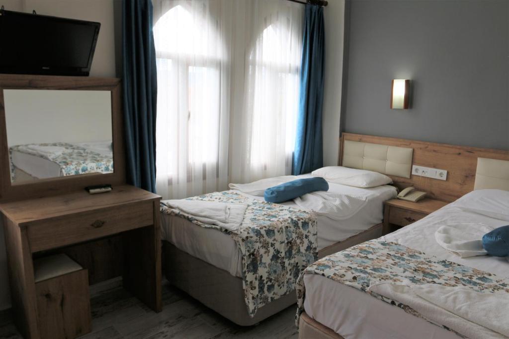 Postel nebo postele na pokoji v ubytování Eroglu City Hotel
