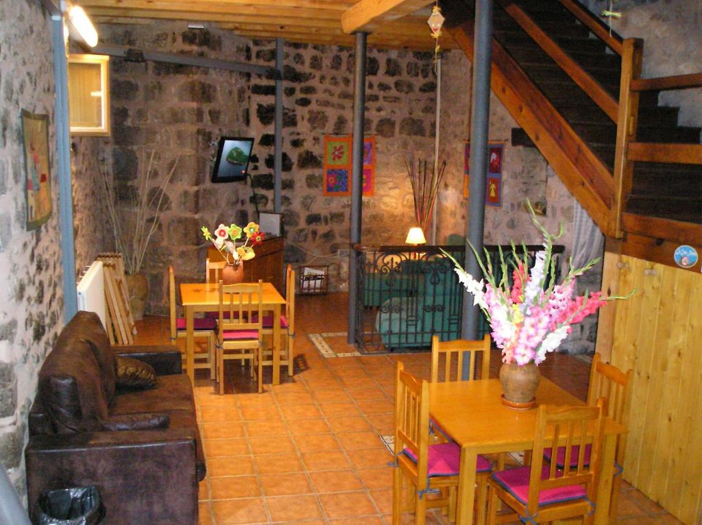 La Casa Nueva في Nieva de Cameros: غرفة معيشة مع طاولات وكراسي وأريكة