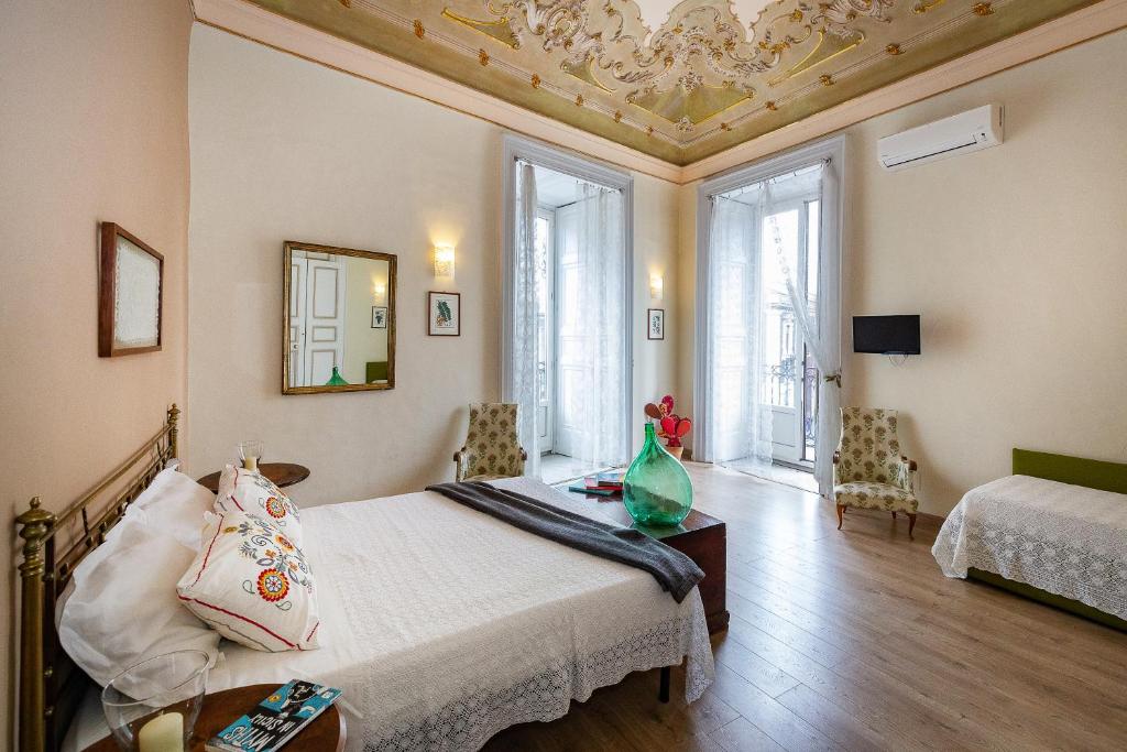 a bedroom with a bed and a table in a room at Acanthus B&B in Catania