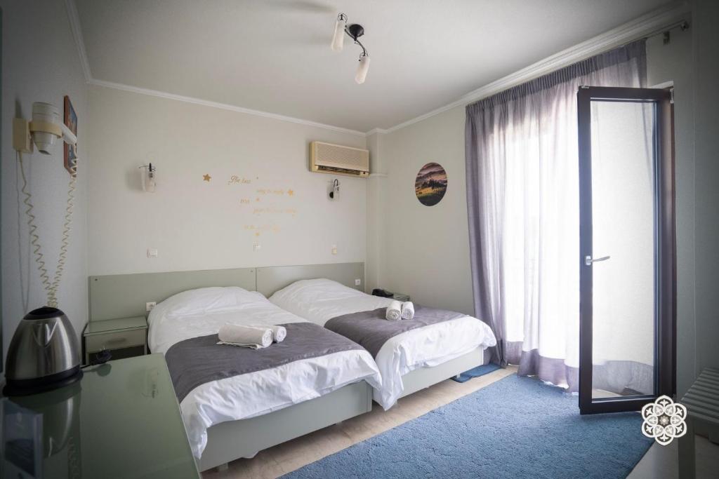 Ένα ή περισσότερα κρεβάτια σε δωμάτιο στο Aktaion Hotel 