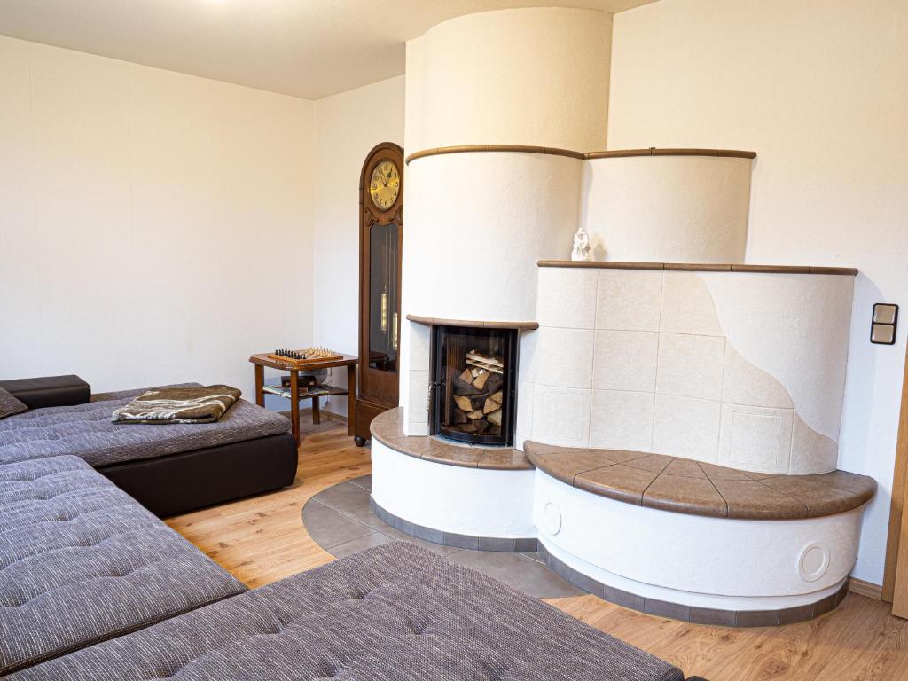 a living room with a fireplace and a couch at Ferienhaus Waldidyll in Lemgo