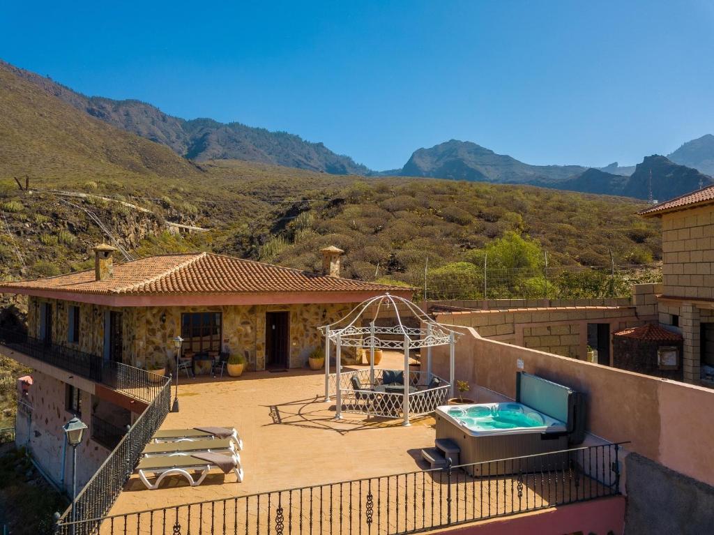 a house with a swimming pool on a balcony at Casa Magma in Adeje