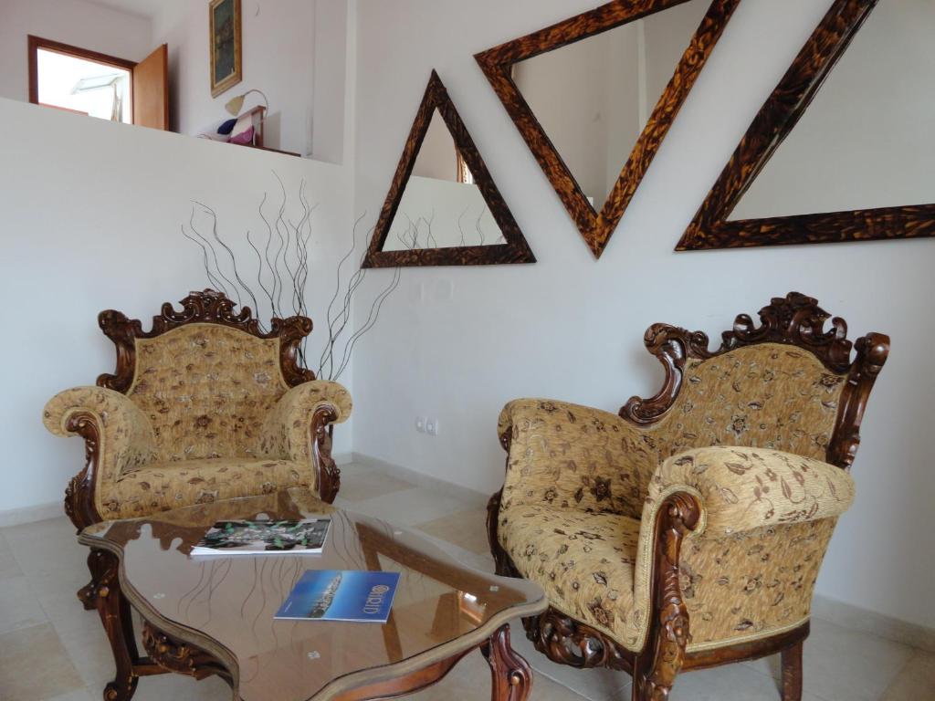 two chairs and a coffee table in a room at Apartments Center in Ohrid