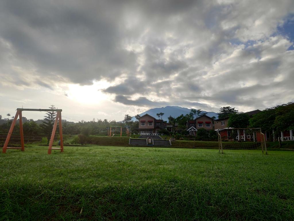 a park with a swing set in a field at Degung Hillside in Bogor