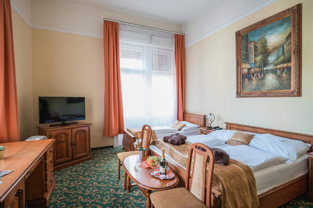 TV a/nebo společenská místnost v ubytování City Hotel UNIO superior
