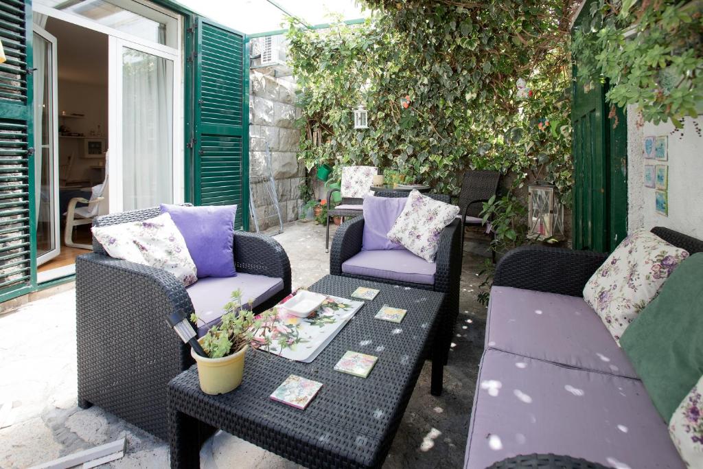 a patio with two wicker chairs and a table at Apartment Nena in Split
