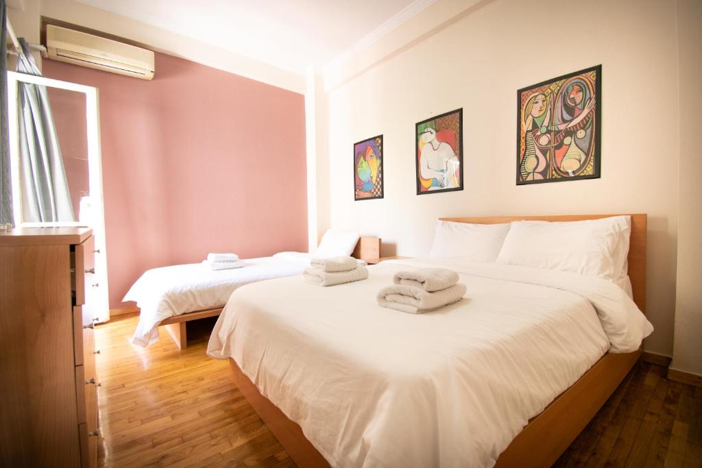 a bedroom with two beds with towels on them at Cozy Flat in Heart of Acropolis in Athens