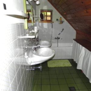 a bathroom with a sink and a toilet and a tub at Ferienhaus Himmelreichmühle in Rettenberg