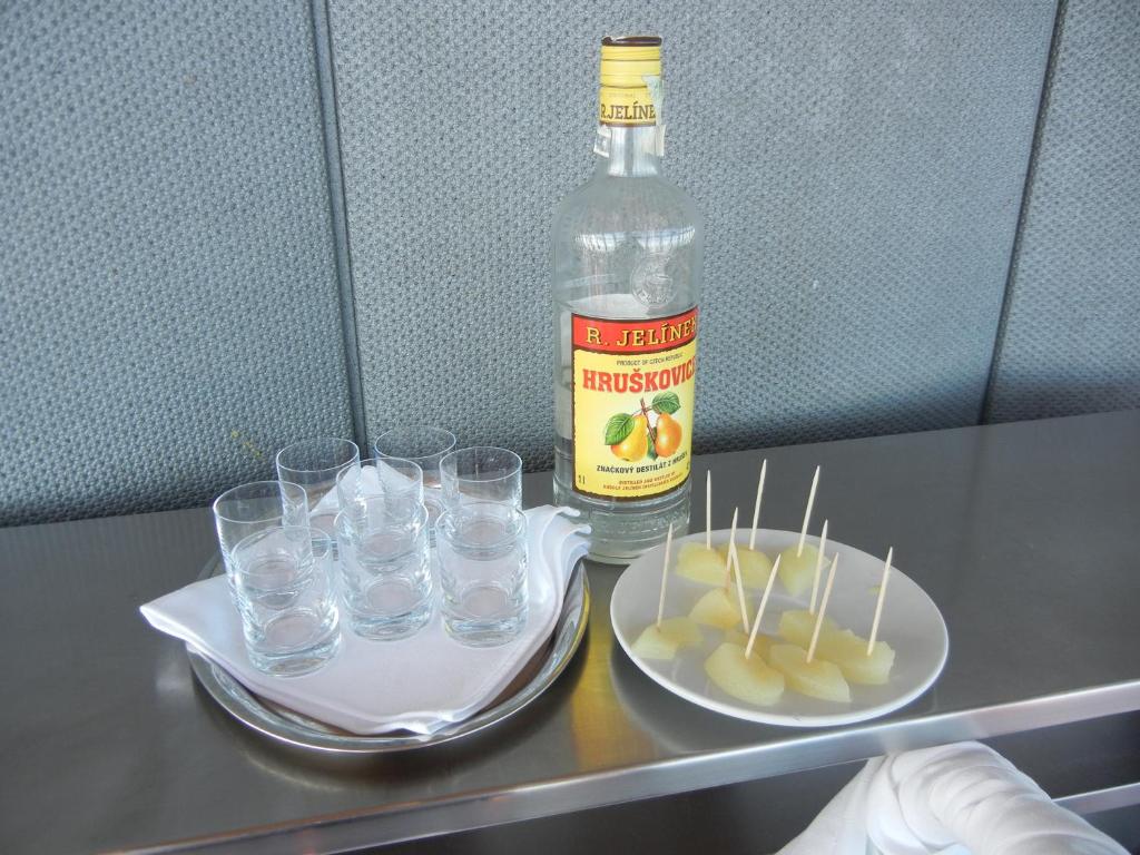 a bottle of water and glasses on a table at Hotel Ještěd in Liberec