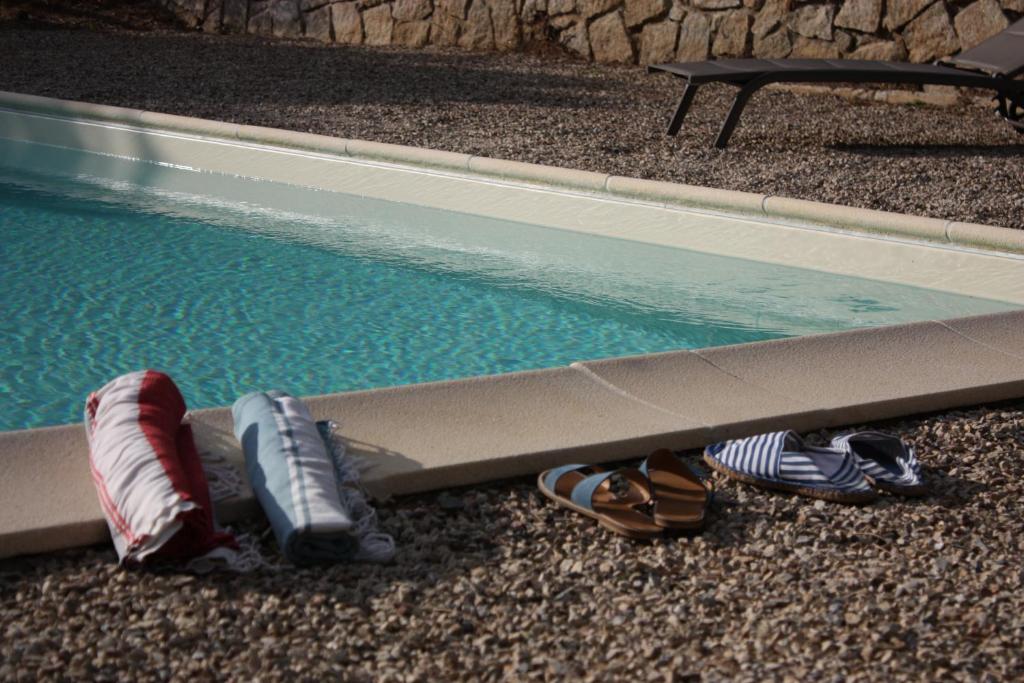 a group of shoes next to a swimming pool at La Grechea Boutique B&B in Casa Alzi