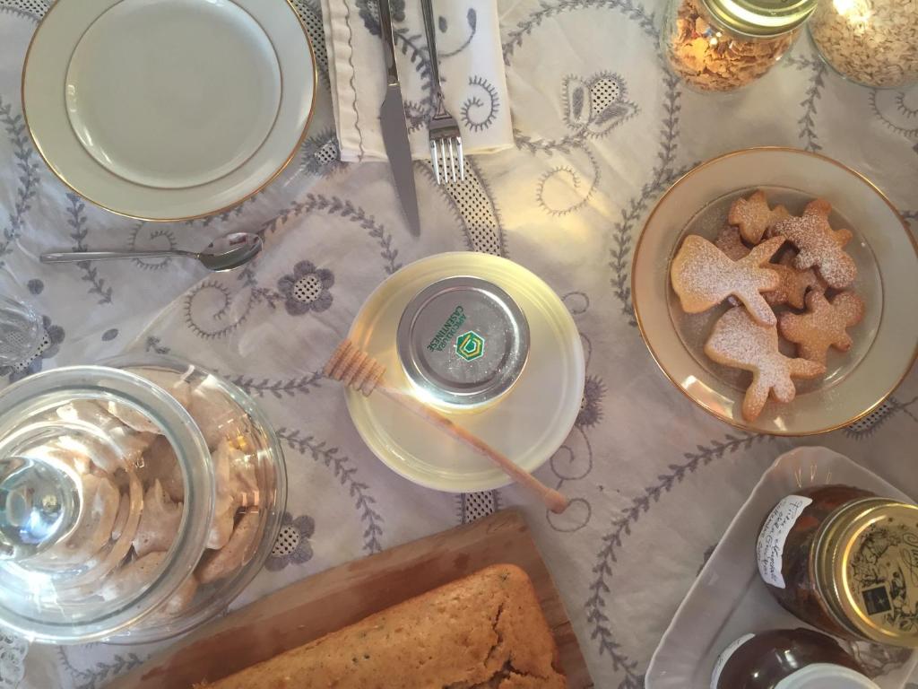 a table with a plate of bread and a glass of wine at La Grechea Boutique B&B in Casa Alzi