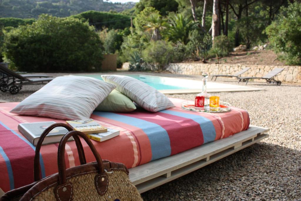 a bed sitting in front of a swimming pool at La Grechea Boutique B&B in Casa Alzi