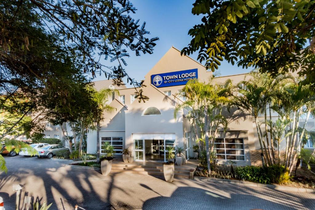 a large white building with a sign on it at Town Lodge Mbombela in Nelspruit